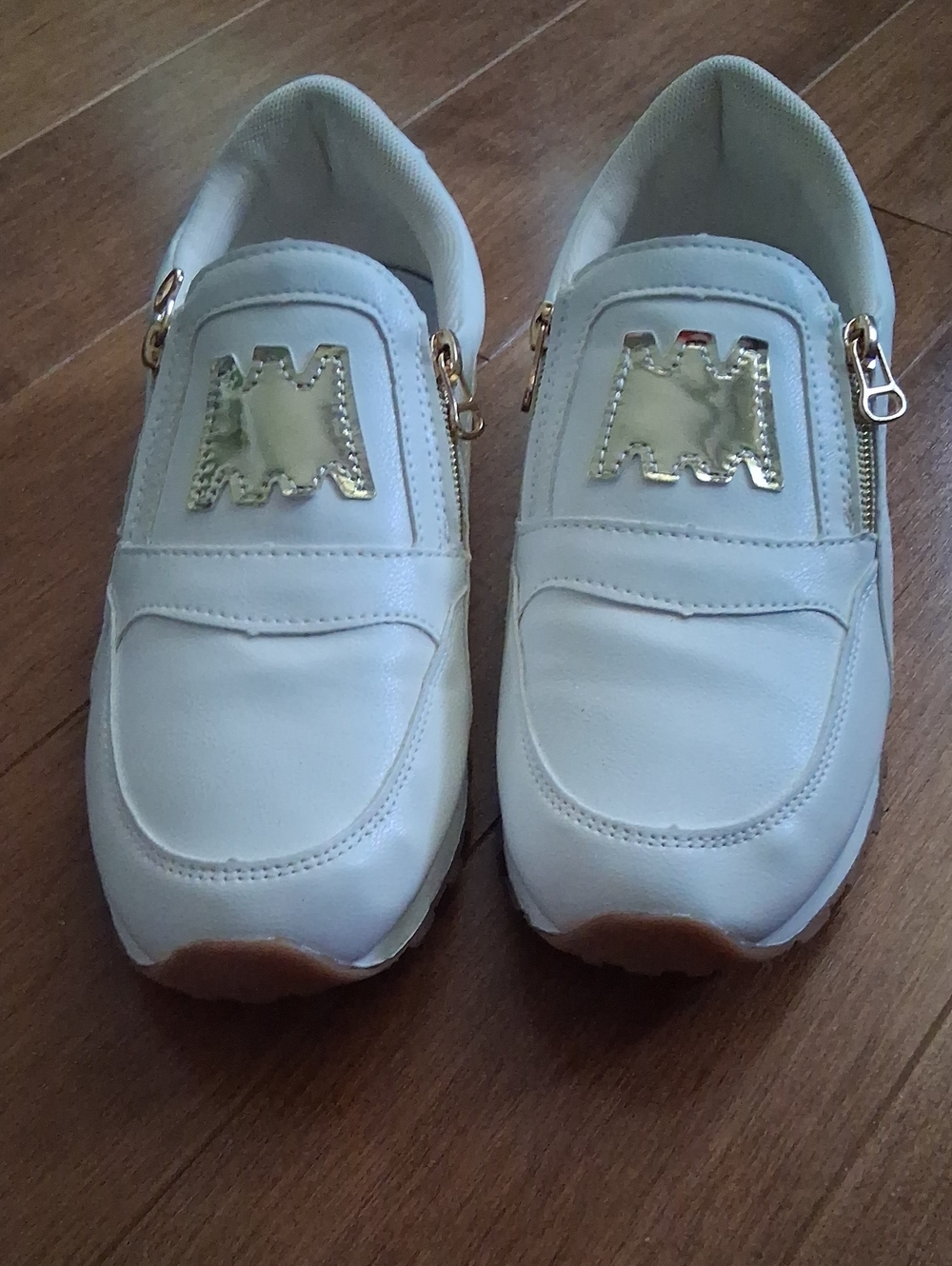Women’s White Slip-On Sneakers with Gold Accent